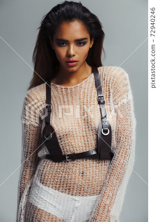 young pretty african woman with fashion makeup and clothers posing sensual on white background, lifestyle people concept 72940246