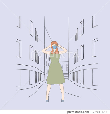 Girl in dress stands on the street wearing a mask. 72941655