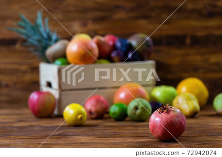 Box full of fresh fruit with pomegranate in main focus 72942074