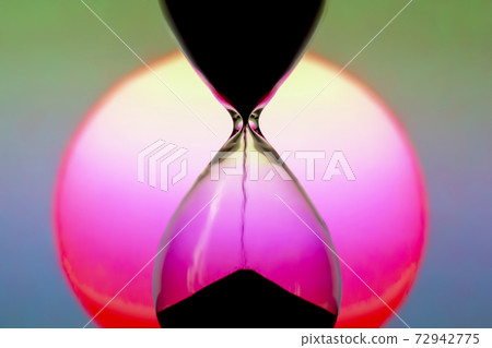 Hourglass on the background of a sunset. The value of time in life. time measuring tool. An eternity. 72942775