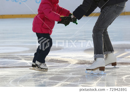 little girl with mother skate on the rink little girl with mother skate on the rink 72942891