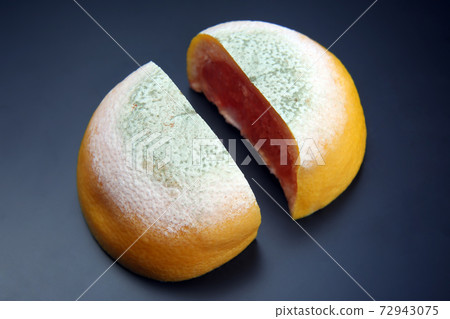 cut the rotting grapefruit on a dark background. cut the rotting grapefruit on a dark background. 72943075