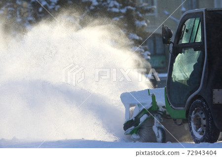street cleaning the city from snow with the help of special machinery 72943404