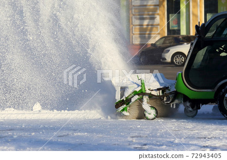 street cleaning the city from snow with the help of special machinery 72943405