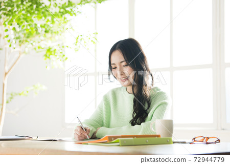 Young woman studying at home Young woman studying at home 72944779