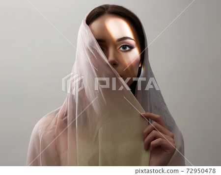 beautiful young woman covered her face. beauty girl in sunlight 72950478