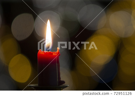 Burning candle on black background with bokeh. Christian christmas concept.. 72951126