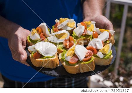 Healthy food for health lifestyle concept with senior manshowing sandwich full of vegetarian - brunch or lunch concept - outdoor people with fresh tasty nutrition 72951837