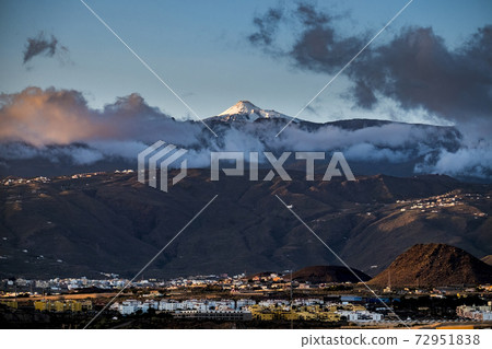 Beautiful landscape with city night lights and big vulcan mountain in background - beauty of tenerife spain Beautiful landscape with city night lights and big vulcan mountain in background - beauty of tenerife spain 72951838
