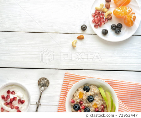Breakfast, oatmeal with blueberry orange and nuts Breakfast, oatmeal with blueberry orange and nuts 72952447