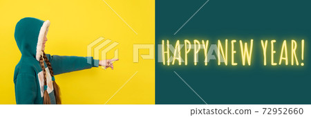 Teen beautiful girl pointing her finger on happy new year. Banner with copy space 72952660