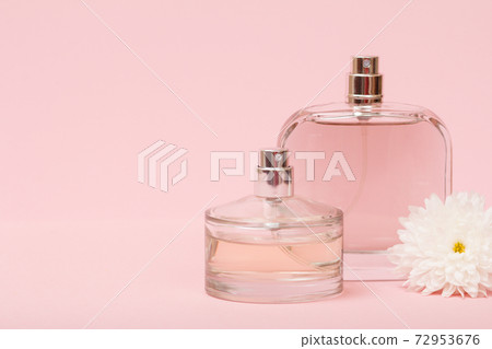 Women perfumes with flower on the pink background. 72953676