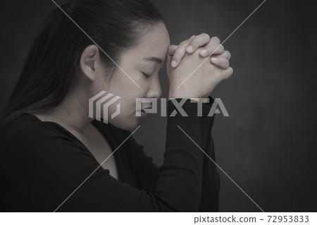 Asian Woman praying and worship to GOD Using hands to pray in religious beliefs and worship christian in the church or in general locations in vintage color tone or copy space. Asian Woman praying and worship to GOD Using hands to pray in religious beliefs and worship christian in the church or in general locations in vintage color tone or copy space. 72953833