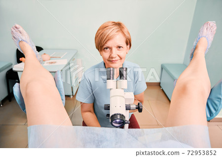 Nice gynecologist examining female patient in clinic. 72953852