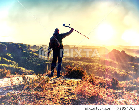 Disabled young man walking on two crutches in landscape. Disabled young man walking on two crutches in landscape. 72954305