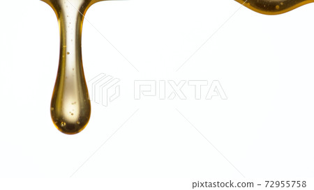 Pouring oil drop isolated on white background. 72955758