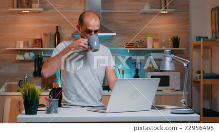 Freelancer working from home drinking coffee 72956498