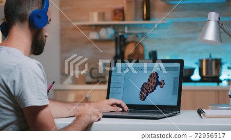 Man architect with wireless headset using laptop Man architect with wireless headset using laptop 72956517