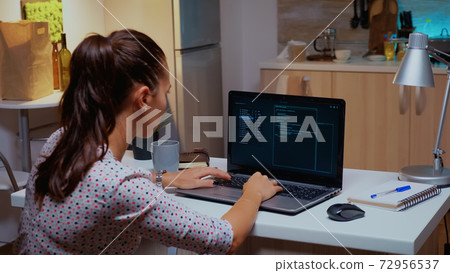 Back view of woman hacker coding a dangerous virus 72956537