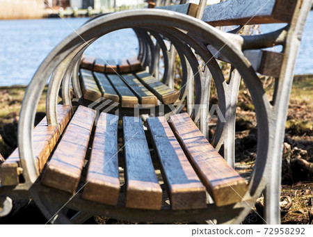 Looking through circular arm of park benches Looking through circular arm of park benches 72958292