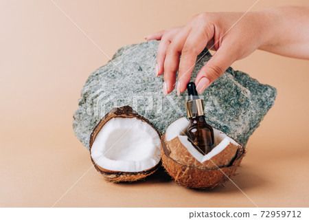 Coconut and a tube of cosmetics on a stone background Coconut and a tube of cosmetics on a stone background 72959712