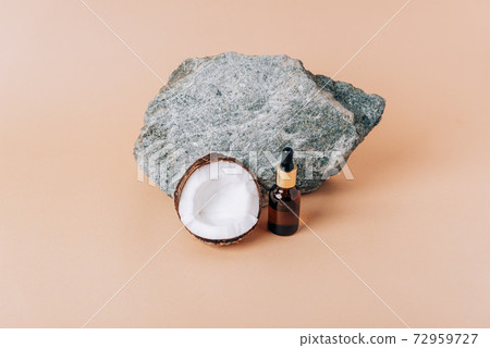 Coconut and a tube of cosmetics on a stone background 72959727