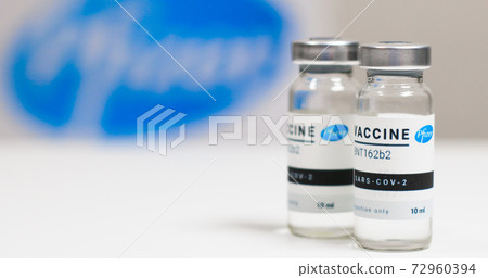 Odessa, Ukraine - December 9, 2020: Scientist or doctor in rubber gloves holds new BNT162b2 vaccine for injection of human volunteers against Sars-cov-2, coronavirus or covid-19. Odessa, Ukraine - December 9, 2020: Scientist or doctor in rubber gloves holds new BNT162b2 vaccine for injection of human volunteers against Sars-cov-2, coronavirus or covid-19. 72960394