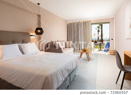Modern design interior of hotel bedroom with soft textile furniture and open terrace with tropic swimming pool Modern design interior of hotel bedroom with soft textile furniture and open terrace with tropic swimming pool 72960507