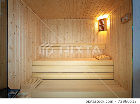 Front view of traditional Finnish sauna room. Empty interior of wooden spa cabin with hot dry steam Front view of traditional Finnish sauna room. Empty interior of wooden spa cabin with hot dry steam 72960512