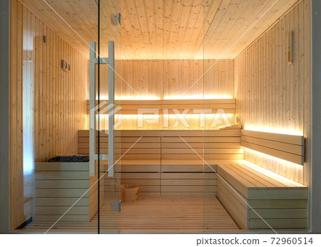 Front view of empty Finnish sauna room. Modern interior of wooden spa cabin with dry steam Front view of empty Finnish sauna room. Modern interior of wooden spa cabin with dry steam 72960514