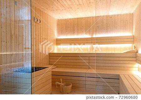 Empty interior of traditional Finnish sauna room. Modern wooden spa therapy cabin with hot dry steam Empty interior of traditional Finnish sauna room. Modern wooden spa therapy cabin with hot dry steam 72960680