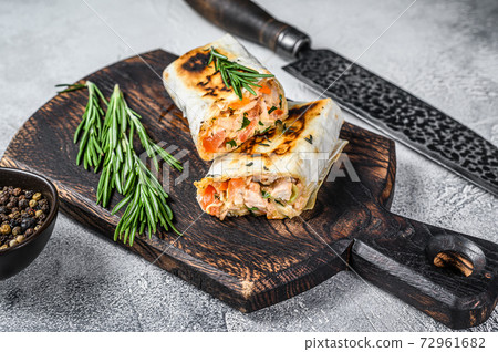 Burrito with grilled chicken and vegetables, fajitas, shawarma. White Wooden background. Top view Burrito with grilled chicken and vegetables, fajitas, shawarma. White Wooden background. Top view 72961682