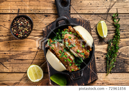 Bao bun, steamed sandwich with pork. Wooden background. Top view Bao bun, steamed sandwich with pork. Wooden background. Top view 72961856