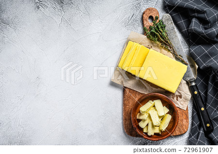 Block of fresh Butter, dairy farm products. Gray background.Top view. Copy space Block of fresh Butter, dairy farm products. Gray background.Top view. Copy space 72961907
