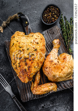 Butchered grilled whole chicken. Black background. Top view Butchered grilled whole chicken. Black background. Top view 72962657