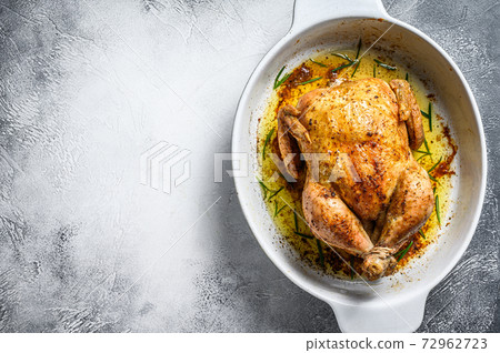 Delicious baked, crispy chicken served on a ceramic dish. White background. Top view. Copy space Delicious baked, crispy chicken served on a ceramic dish. White background. Top view. Copy space 72962723
