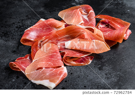 Spanish jamon Serrano, ham. Black background, top view 72962784