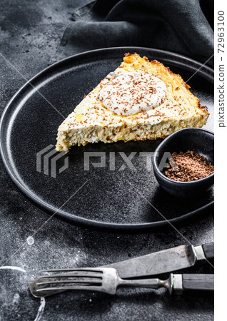 Cottage cheese casserole with chocolate on a plate. Black background. Top view 72963100