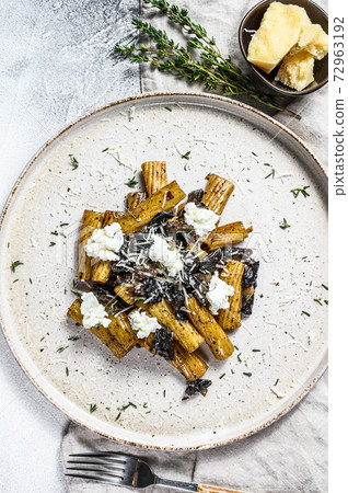 Pasta tortiglioni with black truffle, white mushroom, Cream Sauce and ricotta cheese. Gray background. Top view Pasta tortiglioni with black truffle, white mushroom, Cream Sauce and ricotta cheese. Gray background. Top view 72963192