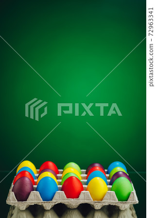 Easter festive multicolor eggs carton, green background Easter festive multicolor eggs carton, green background 72963341