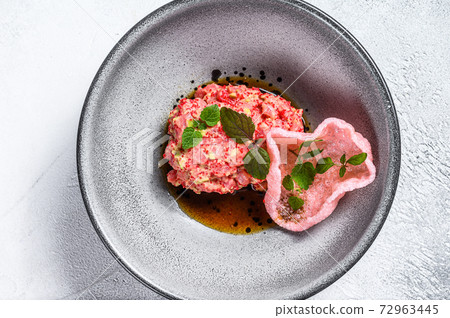 Salmon tartare with avocado and red caviar. White background. Top view. Salmon tartare with avocado and red caviar. White background. Top view. 72963445