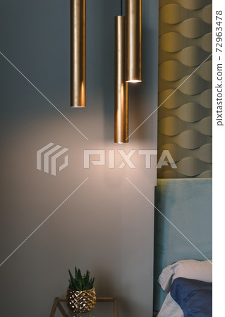 Hanging lamp above bedside table in bedroom at home. Luxury contemporary bedroom initerior. 72963478