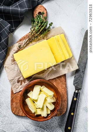 Block of fresh Butter, dairy farm products. Gray background.Top view Block of fresh Butter, dairy farm products. Gray background.Top view 72963818