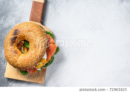 Bagel with salted salmon, cream cheese, avocado and egg. Gray background. Top view. Copy space Bagel with salted salmon, cream cheese, avocado and egg. Gray background. Top view. Copy space 72963825