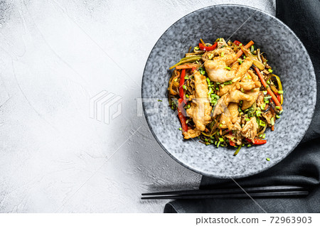 Stir-fry Glass noodle with chicken fillet and vegetables. White background. Top view. Copy space Stir-fry Glass noodle with chicken fillet and vegetables. White background. Top view. Copy space 72963903