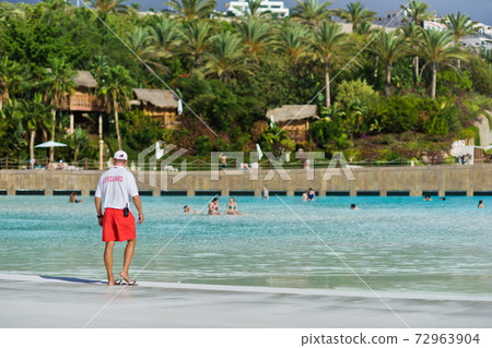 Lifeguard on the beach looking at people. Safety while swimming. Canary Islands, Tenerife. Lifeguard on the beach looking at people. Safety while swimming. Canary Islands, Tenerife. 72963904