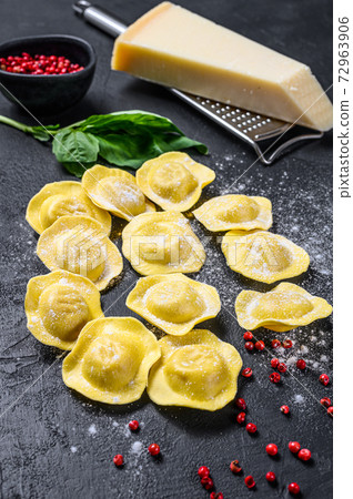 Uncooked fresh ravioli. Home Italian cuisine. Black background. Top view. Uncooked fresh ravioli. Home Italian cuisine. Black background. Top view. 72963906