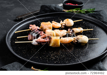 Barbecue with seafood. Kebab on wooden skewers 72964482