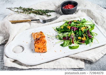 Salmon steak with arugula, lettuce and Salmon steak with arugula, lettuce and 72964870