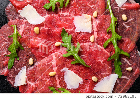 Marbled beef carpaccio with arugula and parmesan Marbled beef carpaccio with arugula and parmesan 72965193